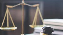 iStock-939262058.jpg Scales of justice and Gavel on wooden table and Lawyer or Judge working with agreement in Courtroom, Justice and Law concept