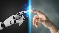 iStock-1419913245.jpg Robot and human hands pointing to each other, the idea of creating futuristic AI, intelligent systems to work instead of humans