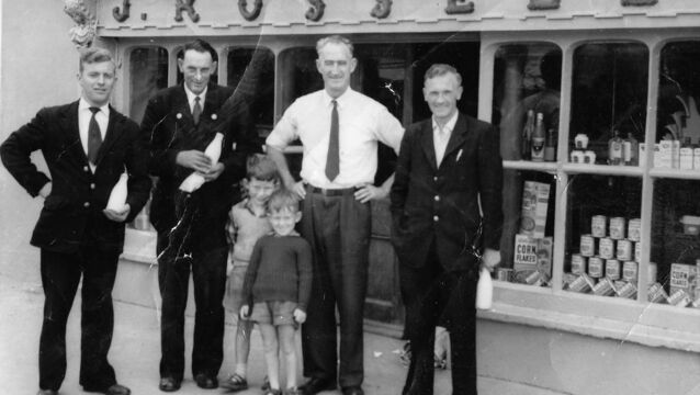 <p>Mick Russell, in white shirt, outside J. Russell, which was the main ship in Whitegate where Micheál Kenefick's sister Joan worked. Picture supplied by Micheál Kenefick</p> <p>Mick Russell, in white shirt, outside J. Russell, which was the main ship in Whitegate where Micheál Kenefick's sister Joan worked. Picture supplied by Micheál Kenefick</p>