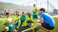 GettyImages-1128844031.jpg Coach talking to soccer players