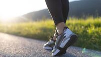 iStock-2199551110.jpg Low Section Of Woman Walking On Road In Mountains