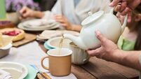 Women cake tea iStock-2235225449.jpg Man Pouring Tea for Young Girl and Woman during Outdoor Gathering