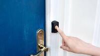 Doorbell iStock-2253847600.jpg Close-up hand of unrecognizable teenager pushing doorbell button in entryway of house building.