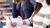 iStock-1216637008.jpg Unrecognizable female college student takes notes in class