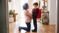 iStock-1154943465.jpg Single Mother At Home Getting Son Wearing Uniform Ready For First Day Of School