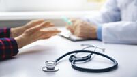 2B0F9FF medical consultation - doctor talking to patient in clinic office. focus on stethoscope