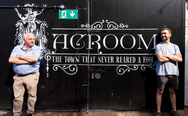 The father and son beside a proud slogan for the town of Macroom. The father and son beside a proud slogan for the town of Macroom.