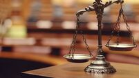 scales-sit-on-a-wooden-table-with-a-blurry-background.jpg Cork man charged with receiving money for work not done remanded in custody
