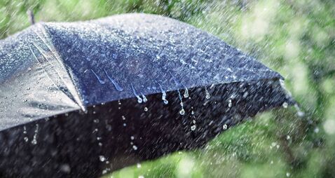 iStock-1757967583.jpg Rain on umbrella background, weather forecast and environment concept
