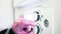 2GY56Y9 A pensioner adjusting the temperature control on his combi boiler. Redcar, UK. 26/5/2021. Photograph: Stuart Boulton.
