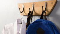 iStock-869848914.jpg School uniform and schoolbag hanging on hook