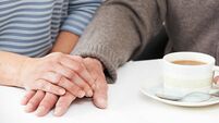 Care of elderly.jpg Close Up Of Woman Sharing Cup Of Tea With Elderly Parent
