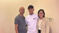 Pic 2 - Denzil Fernandes in scrubs with parents Camilo and Jean.jpeg Cork man kicked his soccer career into touch to become a nurse