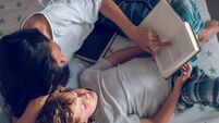 iStock Mother reading.jpg Mother and preteen son lying on bed and reading
