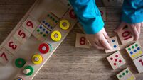 iStock-1049870280.jpg Child playing with mathematical toy