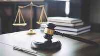 iStock-939262058.jpg Scales of justice and Gavel on wooden table and Lawyer or Judge working with agreement in Courtroom, Justice and Law concept