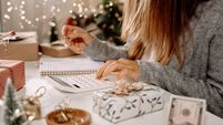 iStock-1352656173.jpg Girl counting US Dollar bills, using calculator, and writing expenses. Woman doing budget, estimating money balance for shopping