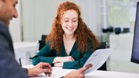 Zurich 1 lead.jpg The office worker presents a document to the client across the desk.