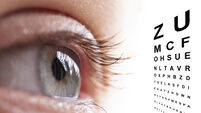 488615658 Close up of an eye and vision test chart