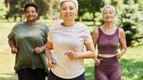 3E7TT1C Asian middle-aged woman in active wear jogging with female friends in the park during daytime