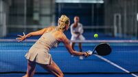 Padel club.jpg Rear view of a female padel player hitting a forehand