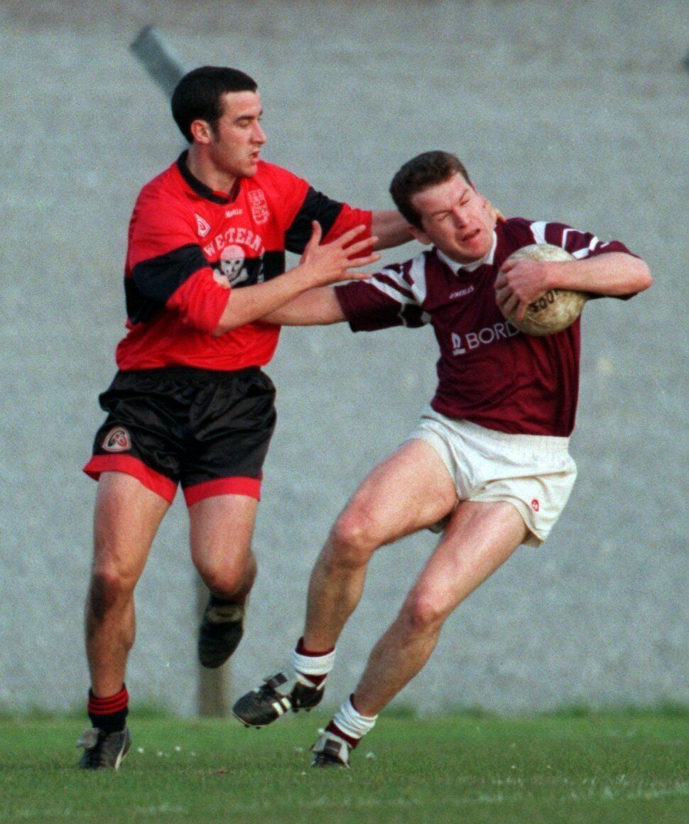 Bishopstown's Paul McGrath is tackled by UCC's Seamus Downey Picture: Eddie O'Hare Bishopstown's Paul McGrath is tackled by UCC's Seamus Downey Picture: Eddie O'Hare