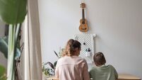 Woman with child homwork iStock-2207029931.jpg Mother and Son doing Homework Together Back View