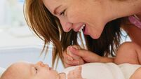 iStock-2230938163.jpg Loving Caucasian Mother Smiling at Newborn Baby Indoors in Bright and Warm Setting